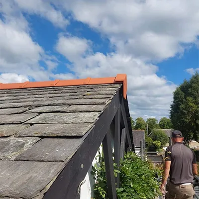 a man standing on the roof of a house