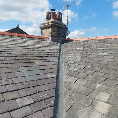 a chimney on top of a roof with a sky background