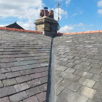 a chimney on top of a roof with a sky background
