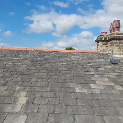 the roof of a house with a chimney